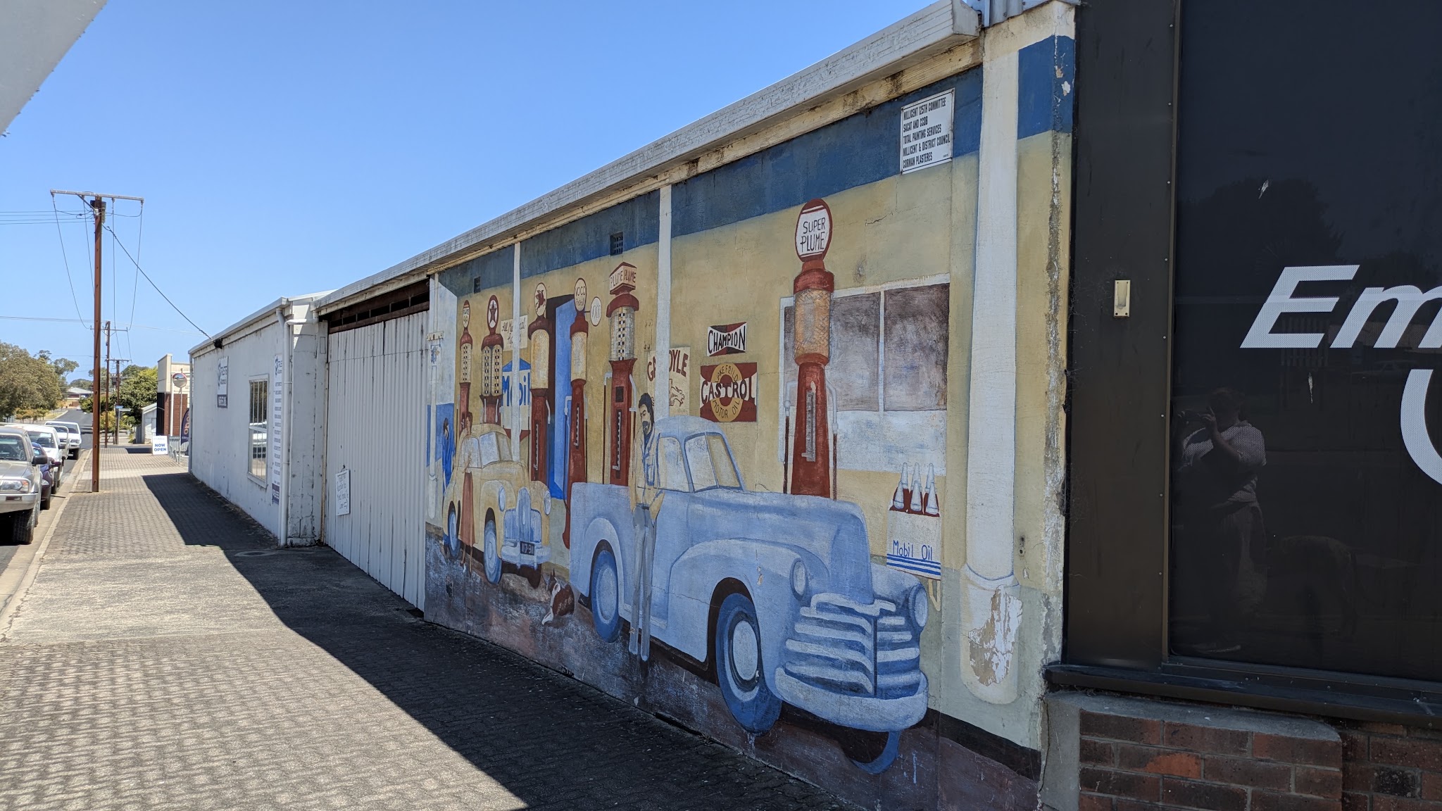 The Trusted Automotive building seen along the George Street footpath, with the mural on the side wall